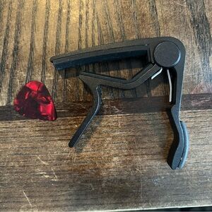Black Guitar Capo with Red Guitar Pick